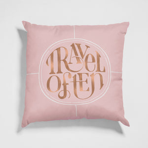 Throw pillow with Travel Often hand lettering in blush and rose gold