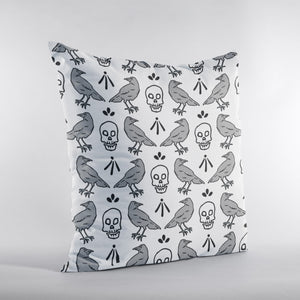 Throw pillow with skull and crow pattern illustration. Grey and Black pattern on white pillow. 