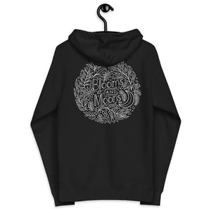 Black zip-up hoodie with Blooms and Moons illustration. Detailed lined work of plant leaves, blooms, and a moon. 